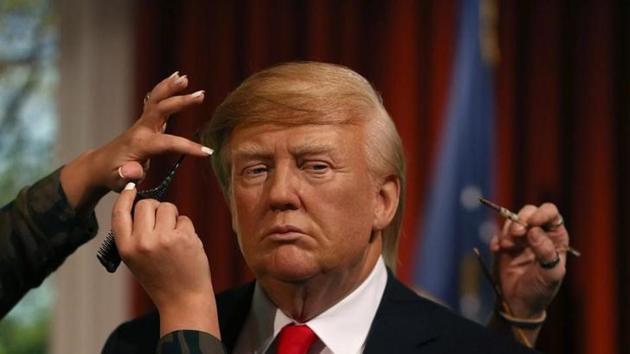 Gallery assistants pose, pretending to put the finishing touches to the hair and make-up of a waxwork of US President-elect Donald Trump, during a media event at Madame Tussauds in London. (Reuters) Gallery assistants pose, pretending to put the finishing touches to the hair and make-up of a waxwork of US President-elect Donald Trump, during a media event at Madame Tussauds in London. (Reuters)