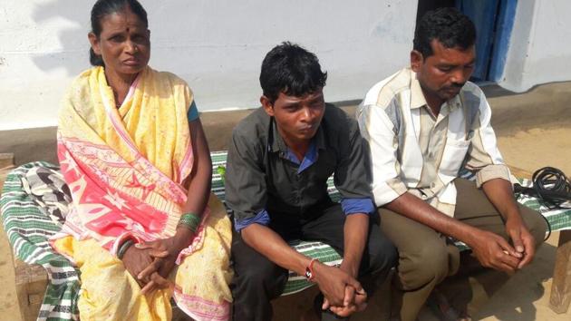 Sunil Uike (centre) with his mother and brother in Balaghat district on Saturday.(HT photo)