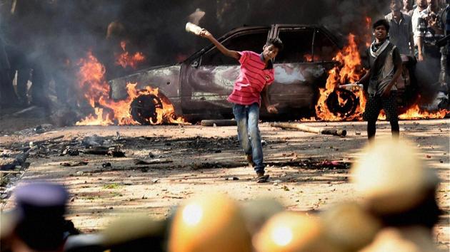 A pro-Jallikattu protester throws bottles at policemen during a clash near Marina Beach in Chennai. (PTI Photo) A pro-Jallikattu protester throws bottles at policemen during a clash near Marina Beach in Chennai. (PTI Photo)