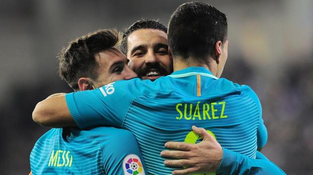 FC Barcelona's Luis Suarez (R) celebrates his goal against SD Eibar with Lionel Messi (L) and Turkish midfielder Arda Turan during their La Liga match on Sunday. (AFP) FC Barcelona's Luis Suarez (R) celebrates his goal against SD Eibar with Lionel Messi (L) and Turkish midfielder Arda Turan during their La Liga match on Sunday. (AFP)