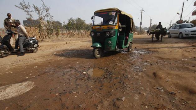 The 18-metre main road of the sector is submerged in dirty water, leaking from the sewage pipeline of neighbouring Kanhai village. (Sanchit Khanna/HT Photo) The 18-metre main road of the sector is submerged in dirty water, leaking from the sewage pipeline of neighbouring Kanhai village. (Sanchit Khanna/HT Photo)