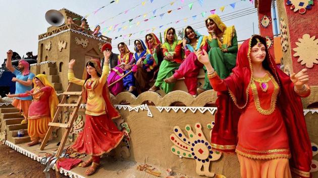 Punjab tableaux artists, participating in the forthcoming Republic Day function, pose for a photo during a press preview in New Delhi on Sunday. (PTI Photo)