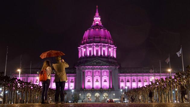 People take a photo as City Hall is bathed lighted in pink after thousands of people marched to protest President Donald Trump and to show support for women's rights in San Francisco. (Josh Edelson/AFP) People take a photo as City Hall is bathed lighted in pink after thousands of people marched to protest President Donald Trump and to show support for women's rights in San Francisco. (Josh Edelson/AFP)