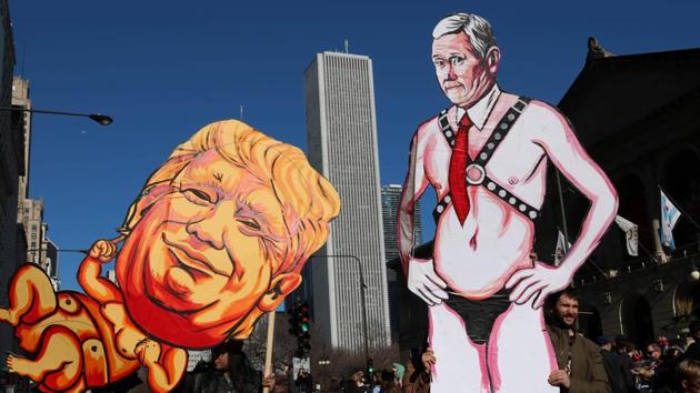Effigies of US President Donald Trump and Vice President Mike Pence are carried through shuttered streets during the Women's March in Chicago. (Derek R. Henkle/AFP) Effigies of US President Donald Trump and Vice President Mike Pence are carried through shuttered streets during the Women's March in Chicago. (Derek R. Henkle/AFP)