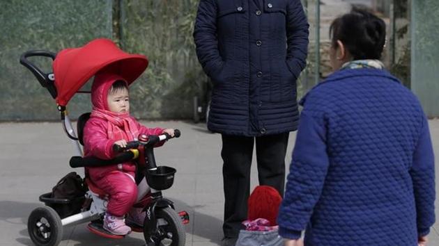 Women with children at a residential community in Beijing, China in 2016. (Reuters) Women with children at a residential community in Beijing, China in 2016. (Reuters)
