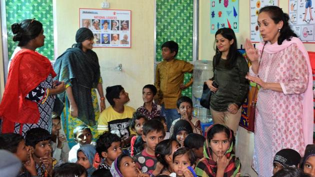 Actor and governing board member of Save the Children Swaroop Rawal interacts with kids at a community centre.(HT photo)