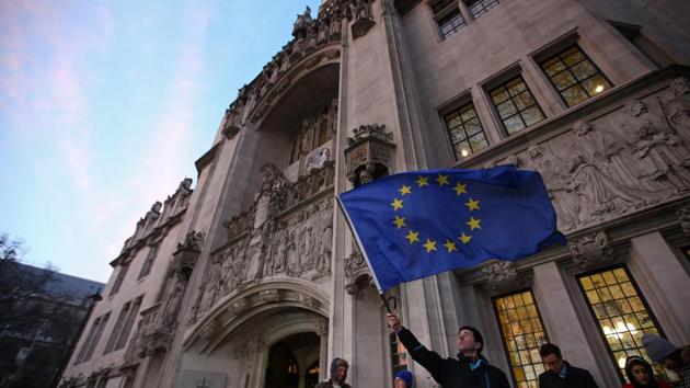 A man waves a European Union flag as he queues to enter the Supreme Court, in central London on Tuesday. (AFP) A man waves a European Union flag as he queues to enter the Supreme Court, in central London on Tuesday. (AFP)