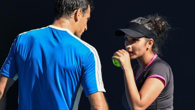 Sania Mirza (R) speaks with Croatia's Ivan Dodig during their mixed doubles match at the Australian Open. (AFP)