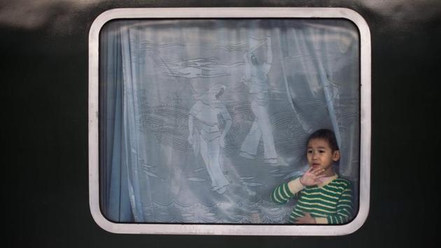 A boy waves from inside a train as he and his family depart for their hometown for the "Spring Festival" or Lunar New Year on January 24, 2017 at Beijing Railway Station. The huge movement of Chinese travelling home to spend the Lunar New Year with their families is often described as the world's largest human migration and overcrowded planes, trains and automobiles are the norm. (AFP Photo) A boy waves from inside a train as he and his family depart for their hometown for the "Spring Festival" or Lunar New Year on January 24, 2017 at Beijing Railway Station. The huge movement of Chinese travelling home to spend the Lunar New Year with their families is often described as the world's largest human migration and overcrowded planes, trains and automobiles are the norm. (AFP Photo)
