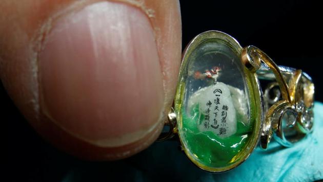 A 1 mm long (0.03 inches) miniature resin figurine of a rooster, is seen inside a ring, created by Taiwanese artist Chen Forng-Shean, ahead of Chinese New Year in New Taipei City, Taiwan January 24, 2017. Picture taken January 24, 2017. (Reuters Photo) A 1 mm long (0.03 inches) miniature resin figurine of a rooster, is seen inside a ring, created by Taiwanese artist Chen Forng-Shean, ahead of Chinese New Year in New Taipei City, Taiwan January 24, 2017. Picture taken January 24, 2017. (Reuters Photo)