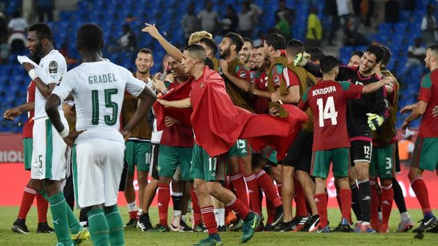 Ivory Coast players (in white) look on as Morocco players celebrate their victory in the Africa Cup of Nations.(AFP)