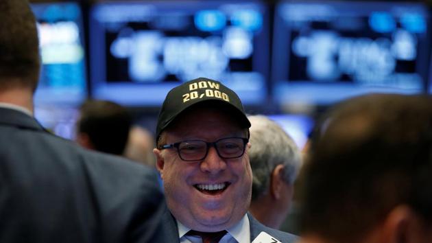 A trader works on the floor of the New York Stock Exchange (NYSE) as the Dow Jones Industrial Average passes the 20,000 mark shortly after the opening of the trading session in New York on Wednesday. (REUTERS)