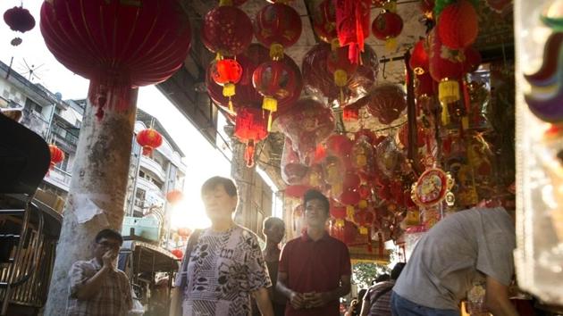 People walk past lanterns and decorations at a market ahead of the Chinese Lunar New Year in Yangon's Chinatown district on January 24, 2017. (AFP Photo) People walk past lanterns and decorations at a market ahead of the Chinese Lunar New Year in Yangon's Chinatown district on January 24, 2017. (AFP Photo)