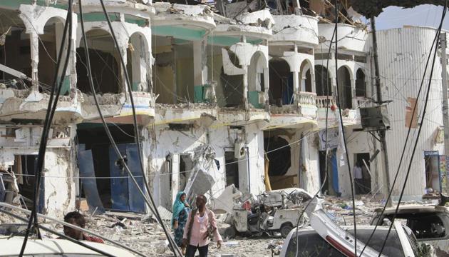Somalis walk near a hotel heavily damaged by a car bomb blast in Mogadishu, Somalia. Gunmen from Somalia's violent Islamic extremist rebels fought their way into a hotel in the Somali capital after a suicide car bomb exploded at its gates, a police officer said Wednesday. (AP Photo) Somalis walk near a hotel heavily damaged by a car bomb blast in Mogadishu, Somalia. Gunmen from Somalia's violent Islamic extremist rebels fought their way into a hotel in the Somali capital after a suicide car bomb exploded at its gates, a police officer said Wednesday. (AP Photo)