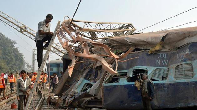 A man cuts an iron frame in front of a damaged coach of a passenger train after it derailed near Kanpur in the northern state of Uttar Pradesh, India, December 28, 2016 (Reuters) A man cuts an iron frame in front of a damaged coach of a passenger train after it derailed near Kanpur in the northern state of Uttar Pradesh, India, December 28, 2016 (Reuters)