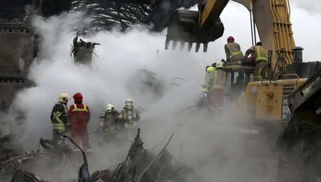 Rescuers work during the operations removing debris of the Plasco building where collapsed after engulfed by a fire on Thursday, in central Tehran, Iran, Tuesday, Jan. 24, 2017. Rescue teams are trying to reach missing firefighters, victims and looking for survivors believed to be under the rubble of the Plasco high-rise commercial building. (AP Photo) Rescuers work during the operations removing debris of the Plasco building where collapsed after engulfed by a fire on Thursday, in central Tehran, Iran, Tuesday, Jan. 24, 2017. Rescue teams are trying to reach missing firefighters, victims and looking for survivors believed to be under the rubble of the Plasco high-rise commercial building. (AP Photo)
