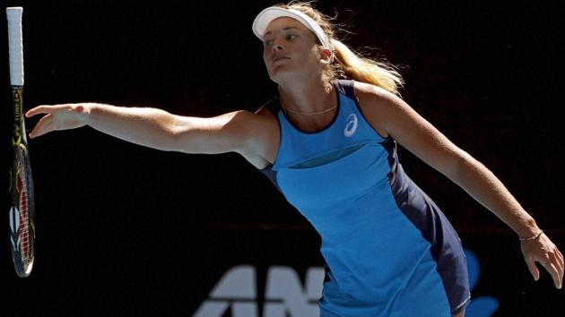 Coco Vandeweghe reaches for a racket after she bounced it during her Australian Open semifinal against Venus Williams. (AP)