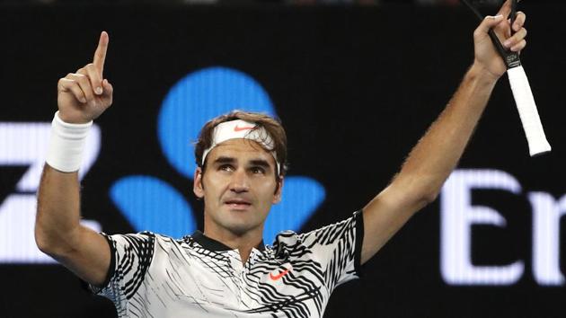 Roger Federer celebrates after defeating compatriot Stan Wawrinka in their semi-final at the Australian Open.(AP)