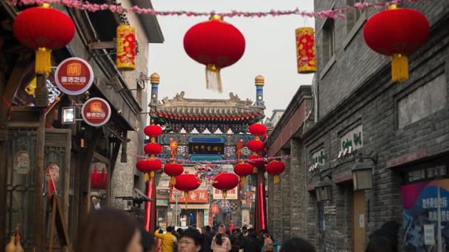 People walk under lanterns displayed ahead of the Lunar New Year in Beijing on January 25, 2017. (AFP) People walk under lanterns displayed ahead of the Lunar New Year in Beijing on January 25, 2017. (AFP)