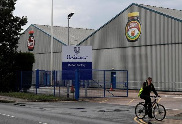 A man cycles past Unilever's Marmite factory in Burton upon Trent, Britain (Reuters)