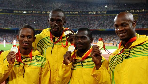 (left to right) Michael Frater, Usain Bolt, Nesta Carter and Asafa Powell receive their gold medals after the Jamaican quartet won the 4x100m relay gold with a world record at the 2008 Beijing Olympics. Carter’s positive in a re-test has led to Bolt losing one of his nine gold medals.(Getty Images)