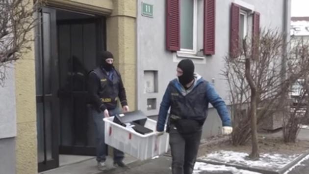 In this image from video masked police officers carry computers out of a house in Graz, Austria, Thursday. (AP Photo) In this image from video masked police officers carry computers out of a house in Graz, Austria, Thursday. (AP Photo)