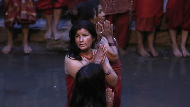 Women get ready to take holy dip at the Bagmati River during Madhav Narayan festival in Kathmandu. (Niranjan Shrestha / AP)