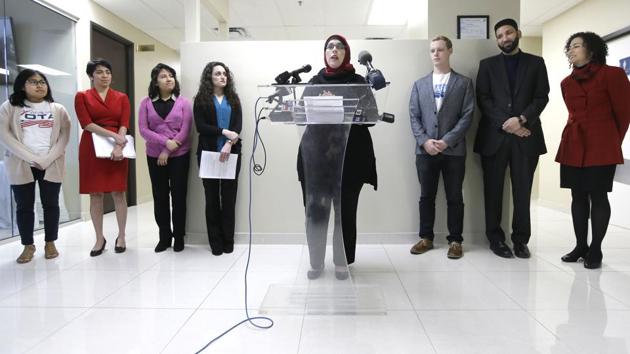 Alia Salem, center, executive director of the Dallas/Fort Worth chapter of the Council on American-Islamic Relations, leads a news conference with community activists concerning recent executive orders by President Donald Trump, Thursday, Jan. 26, 2017, in Dallas.(AP Photo)
