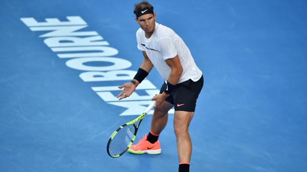 Spain's Rafael Nadal questions his team on the number of challenges remaining during his men's singles semi-final match against Grigor Dimitrov. (AFP)