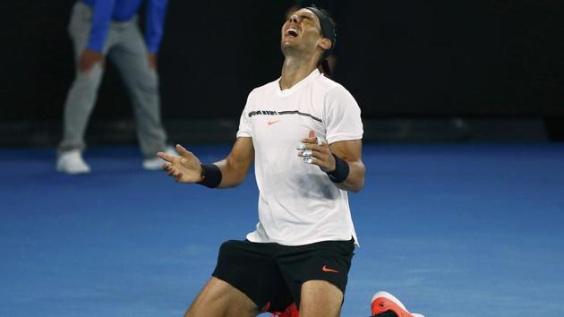 Rafael Nadal falls onto the court as he celebrates winning his Men's singles semi-final match. (REUTERS)