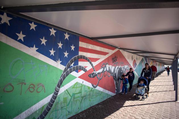 People walk on at Otay's Pedestrian Crossing on the Mexican side of the US-Mexico border, on the outskirts Tijuana, northwestern Mexico. (AFP Photo)