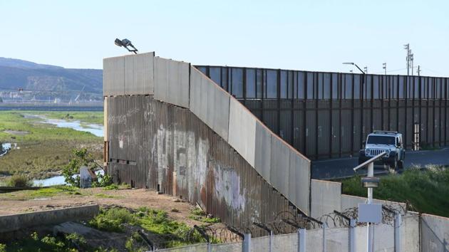 A border patrol vehicle sits along the US-Mexico border wall in San Ysidro, California. . (AFP Photo)