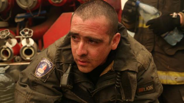 A firefighter takes a break as he and colleagues try to extinguish wildfires. (Pablo Sanhueza/REUTERS) A firefighter takes a break as he and colleagues try to extinguish wildfires. (Pablo Sanhueza/REUTERS)