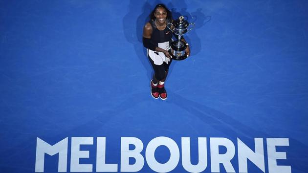 Serena Williams gives the perfect pose with the Australian Open trophy on Saturday. (AP)