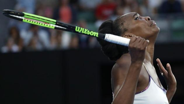 Venus Williams looks up after losing a point to her sister Serena. (AP)