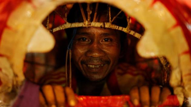 A dancer is seen inside of a Chinese lion's head during the Lunar New Year's eve celebration in Chinatown, in Bangkok, Thailand. (REUTERS)