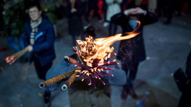 A man prays with incense sticks at the Longhua temple in Shanghai. China marks the beginning of the Lunar New Year, the Year of the Rooster. (Johannes Eisele/AFP)