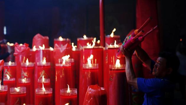 A man lights incense sticks during Lunar New Year celebrations at Dharma Bhakti temple in Jakarta, Indonesia. (Darren Whiteside/REUTERS)