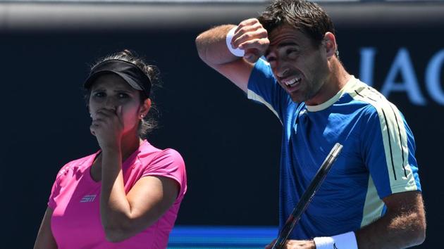 India's Sania Mirza speaks with Croatia's Ivan Dodig during their mixed doubles quarter-final match against Canada's Gabriela Dabrowski and India's Rohan Bopanna in Australian Open in Melbourne on January 25, 2017.(AFP)