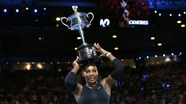 Serena Williams places the Australian Open trophy on her head. (REUTERS)