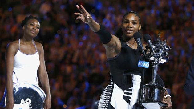 Serena Williams gestures while holding the trophy after winning the Australian Open final. (REUTERS)