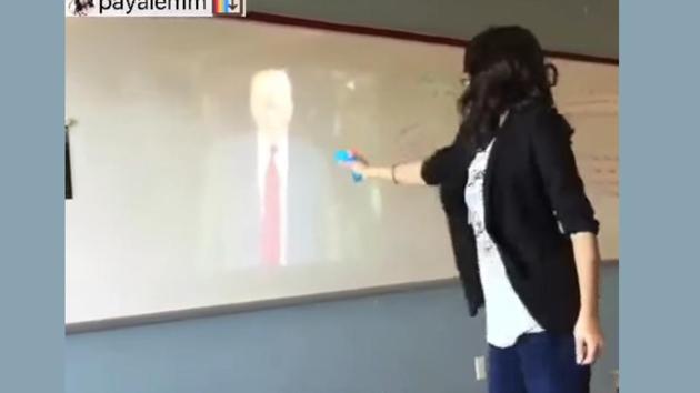 An eight-second video was posted to a personal Instagram account on January 20, the date of Trump’s inauguration, showing Payal Modi holding a water gun, pointing it at an image of Trump projected onto a whiteboard, and yelling “Die!” as she shoots the gun.(YouTube screengrab)
