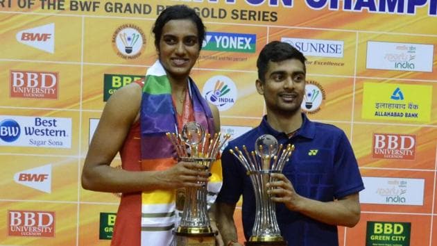 PV Sindhu (left) and Sameer Verma with their trophies at the Syed Modi International Grand Prix meet in Lucknow, on Sunday.(HT Photo)