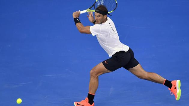 Rafael Nadal goes for a backhand return to Roger Federer during their Australian Open final on Sunday. (AP)