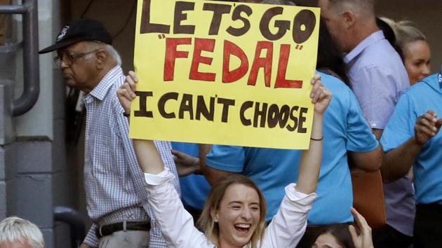 A spectator holds up a banner ahead of the men's final in Melbourne on Sunday. (AP)