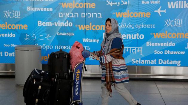 A woman exits immigration after arriving from Dubai on Emirates Flight 203 at John F Kennedy International Airport in Queens, New York. (REUTERS)