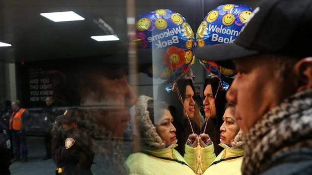 A family waits for someone as protesters gather outside Terminal 4 at JFK airport in opposition to U.S. President Donald Trump's proposed ban on immigration and travel in Queens, New York City, New York, U.S. January 28, 2017. (Reuters Photo) A family waits for someone as protesters gather outside Terminal 4 at JFK airport in opposition to U.S. President Donald Trump's proposed ban on immigration and travel in Queens, New York City, New York, U.S. January 28, 2017. (Reuters Photo)