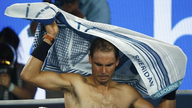 Rafael Nadal covers himself with a towel during his final against Roger Federer. (REUTERS)