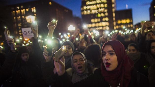 Muslim women shout slogans during a rally against President Donald Trump’s order cracking down on immigrants living in the US at Washington Square Park in New York on Wednesday.(AP Photo)