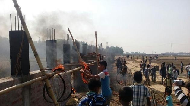Villagers chased away workers and threw burning tyres at the construction site on Monday morning.(HT Photo)